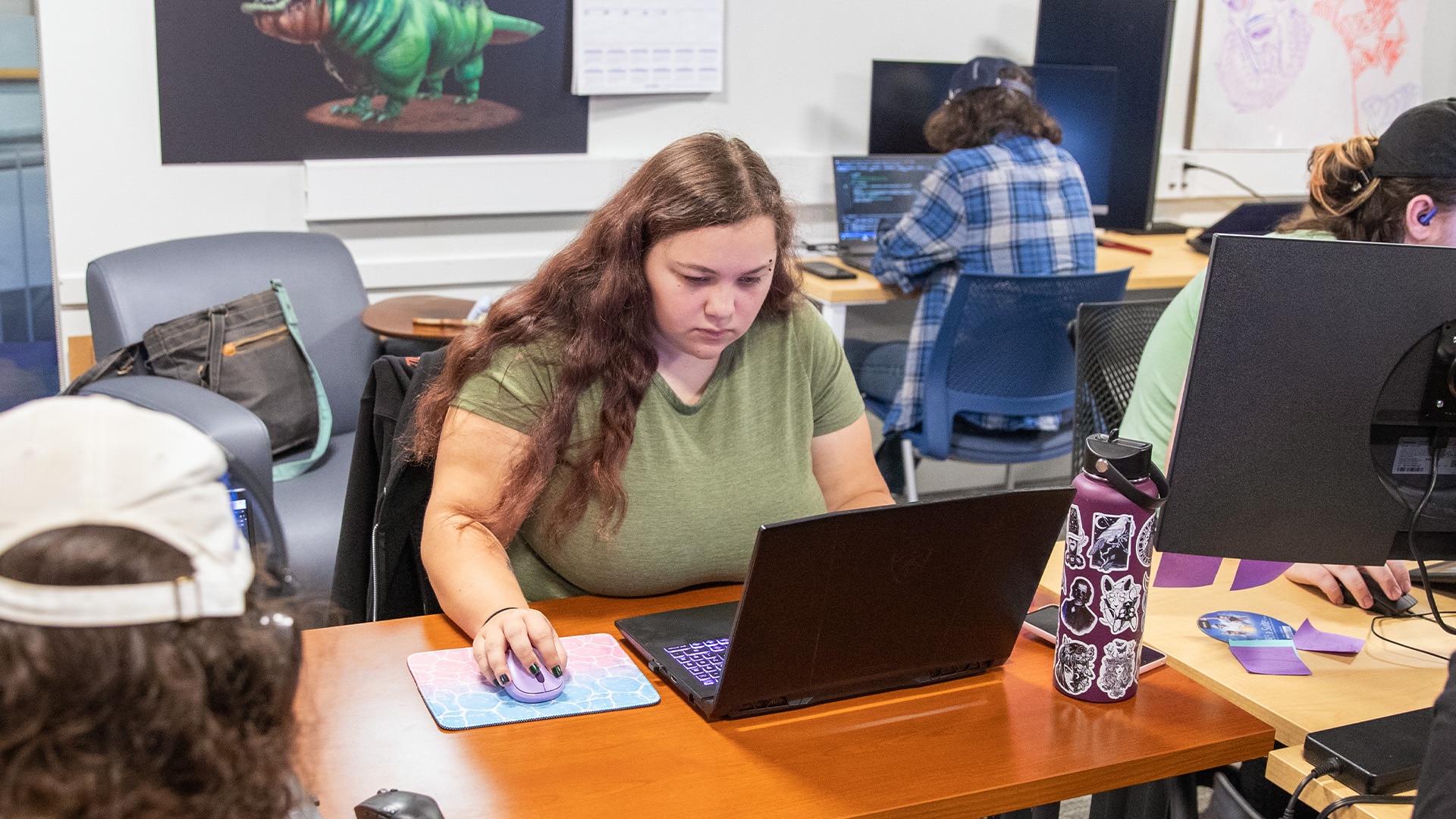 Students working on their laptops in a lab setting. 
