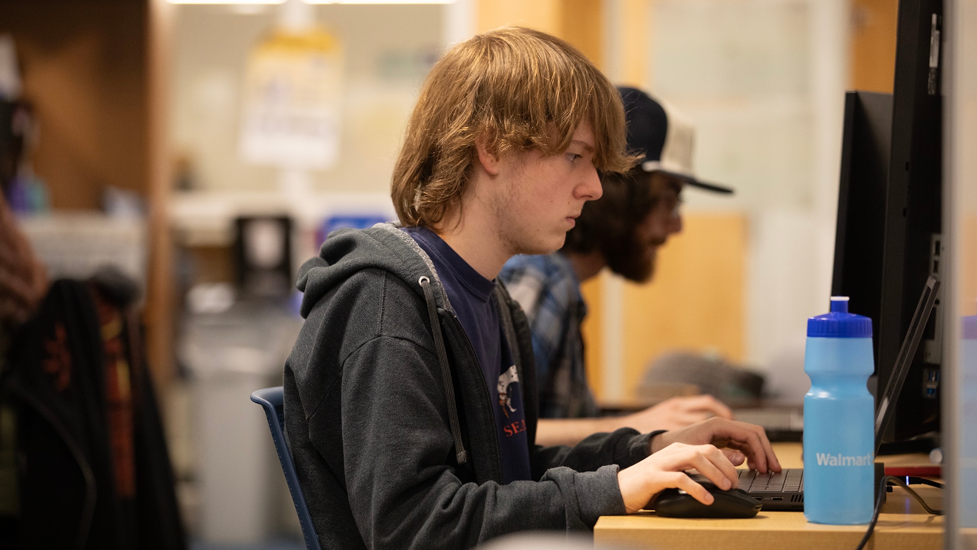An individual working on a laptop.