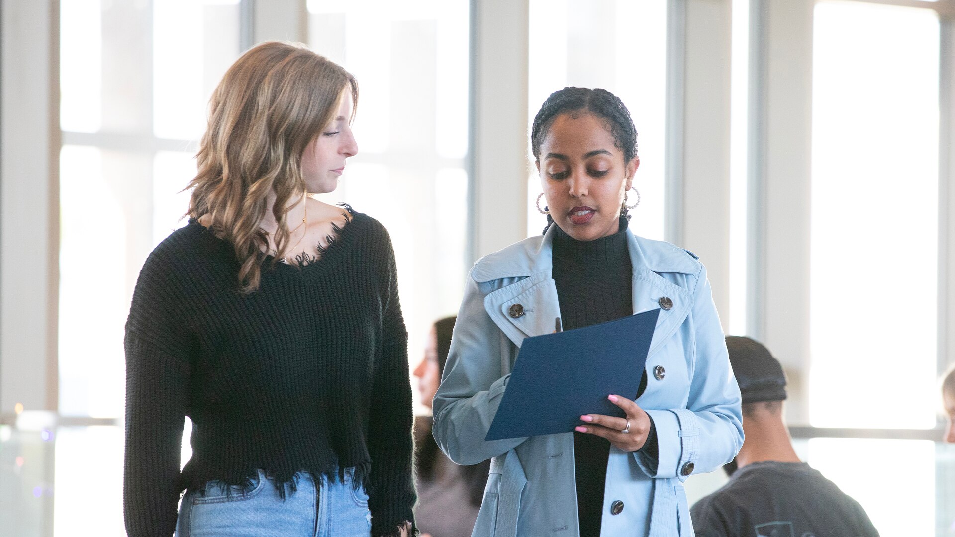 Two students in discussion with each other.