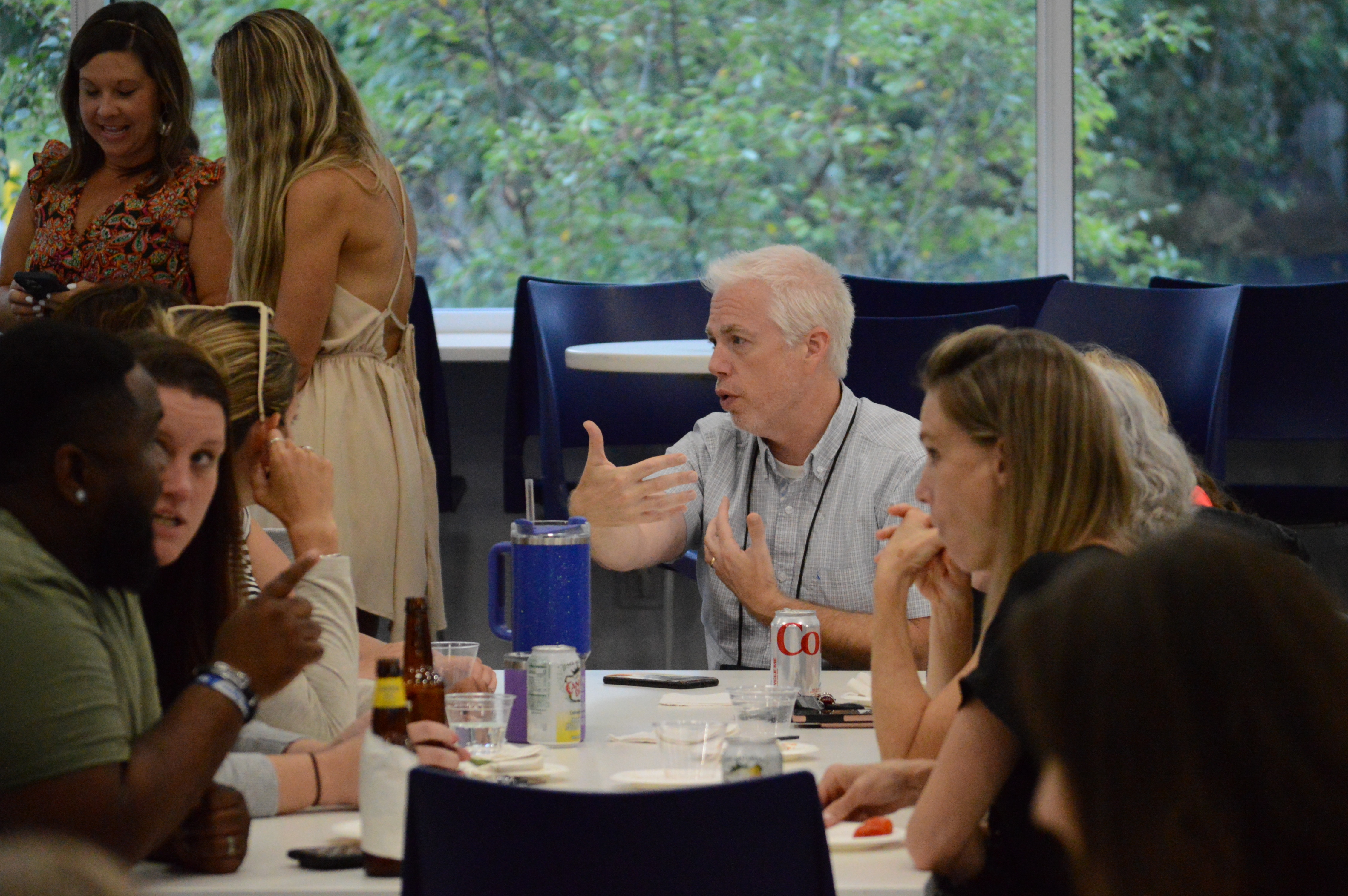 SNHU Educational Leadership Residency students sitting around a table, having a discussion.