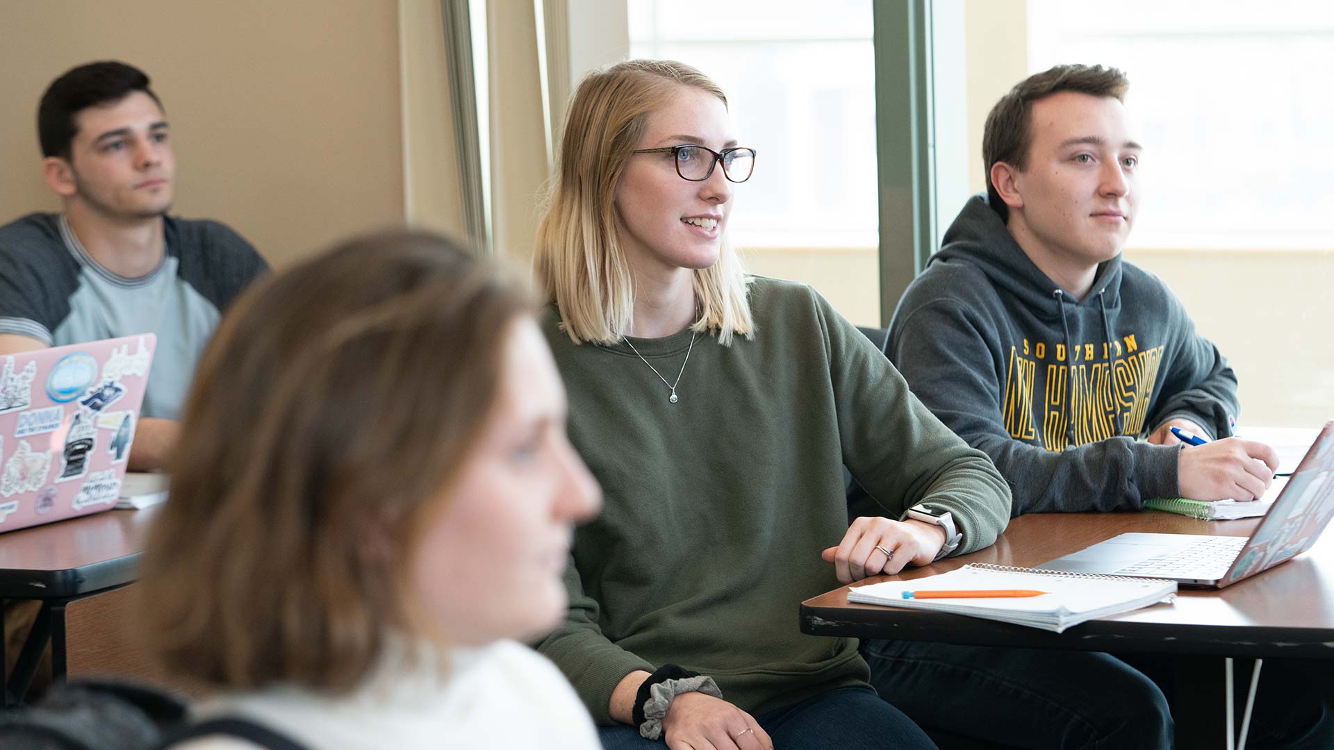 Students studying in the classroom and asking questions.
