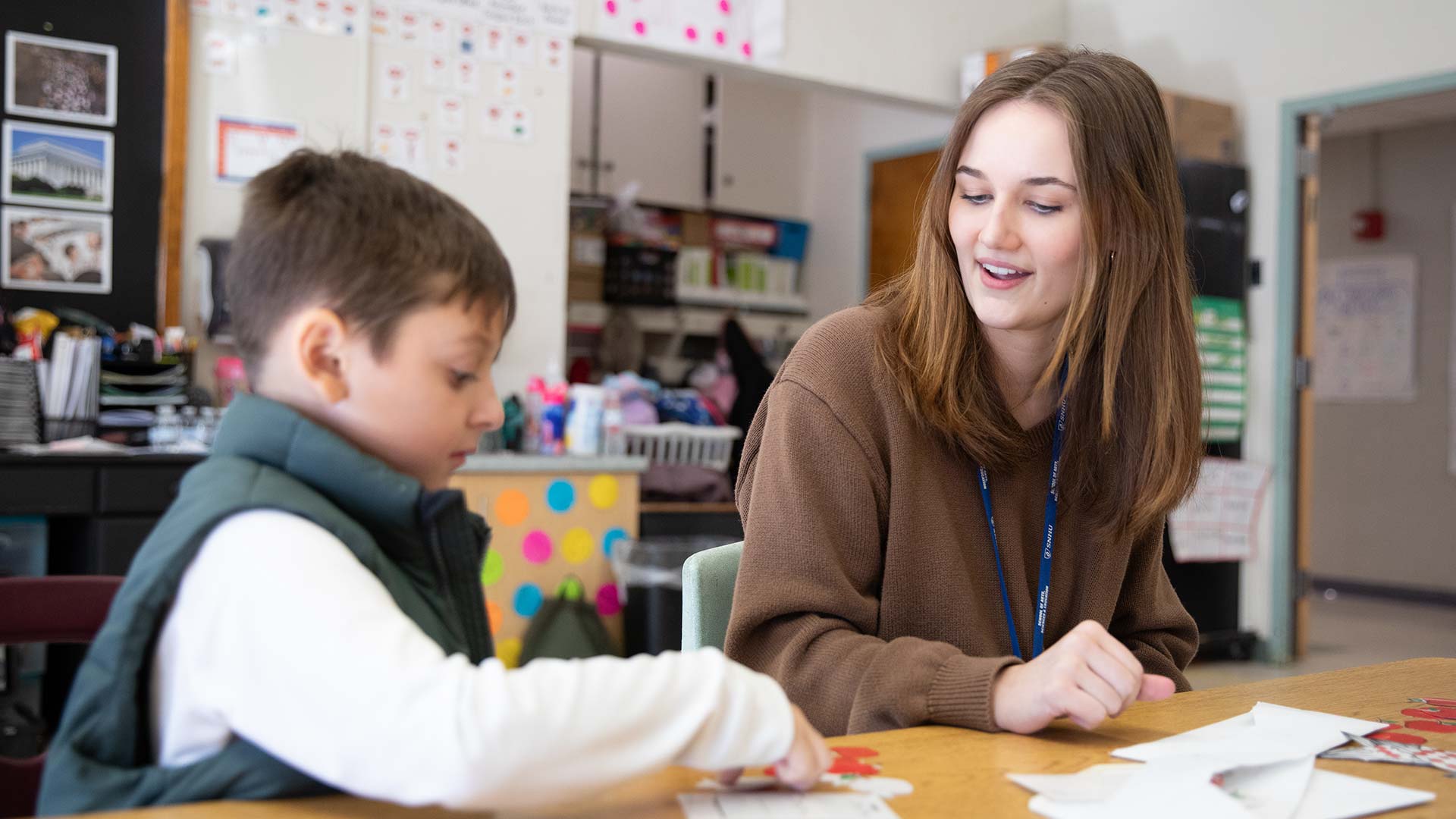MeD Student Faculty with Elementary School Student in the classroom.