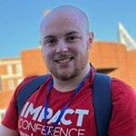 SNHU student Kyle Furey ’25 ’27G wearing a red shirt outdoors.
