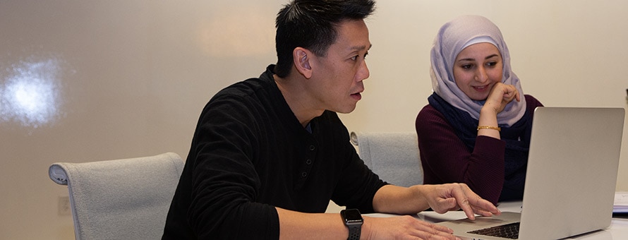 Two students working on a computer