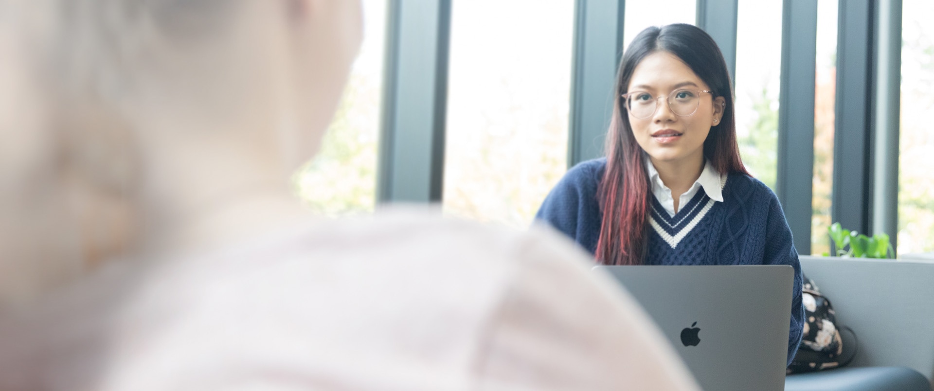 Two students in conversation with each other.