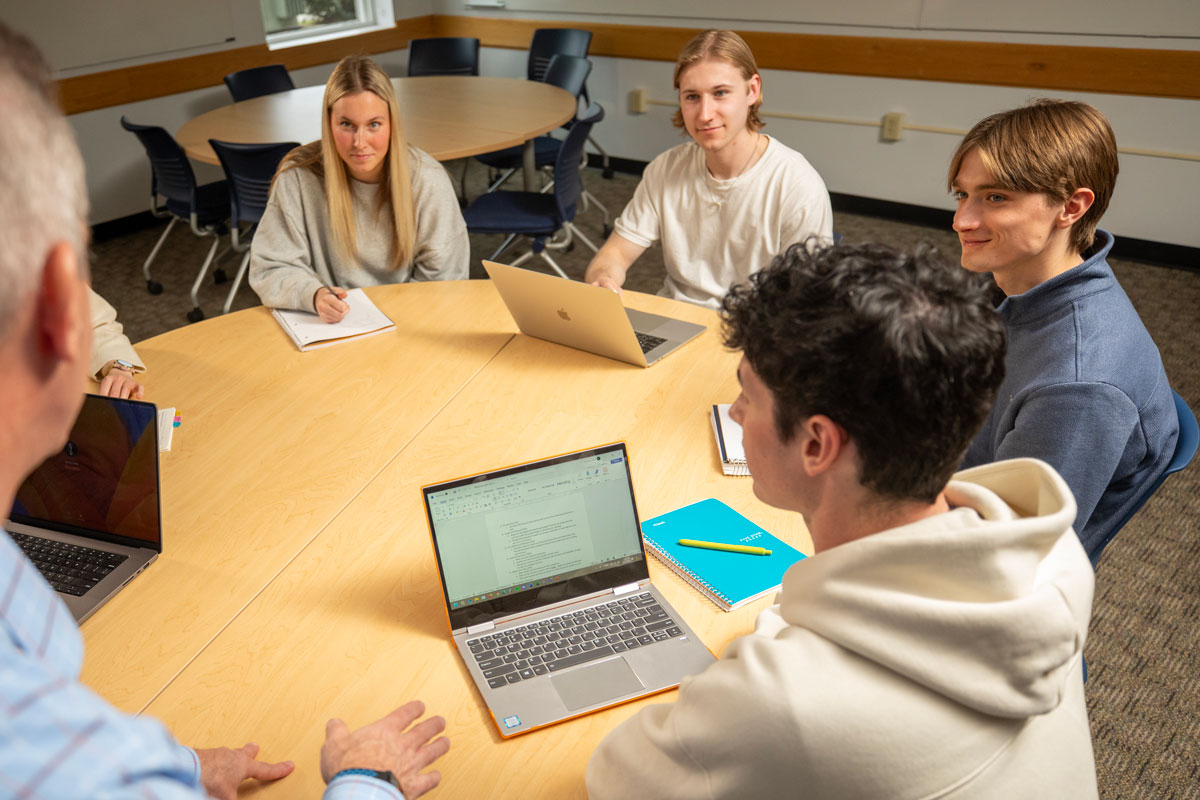 SNHU campus students at a table. 