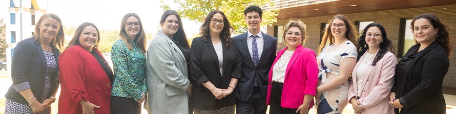 Group photo of SNHU campus admission counselors standing outdoors together.