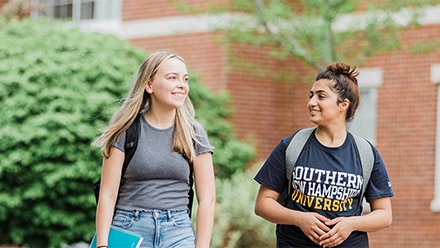 Two students walking on campus