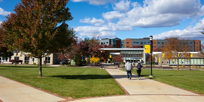 Students walking towards campus during fall