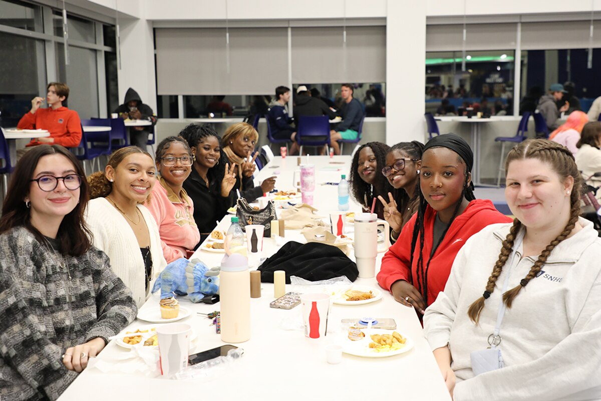 A group of SNHU campus students participating in the Late Night Breakfast event